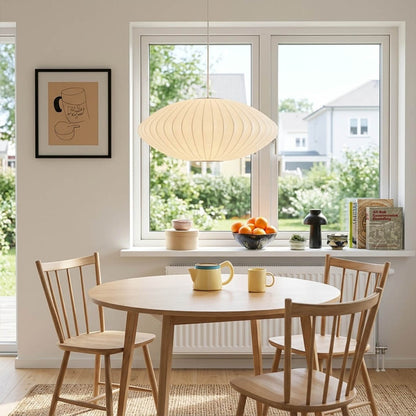 Nelson style bubble Saucer pendant 24 inch above Mid Century dining table Eames era furniture warm white glow modern interior