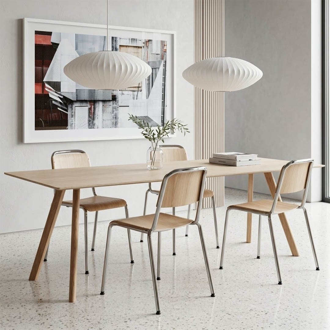 Nelson style bubble Cigar drum pendant pair above modern kitchen island Mid Century white spun polymer architectural warm glow interior