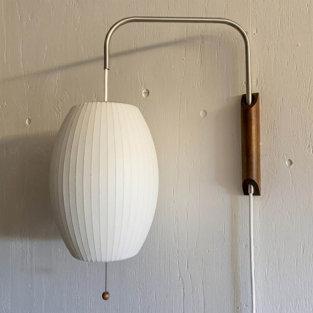 Nelson style bubble wall sconce pair bedside primary bedroom mid century modern plug in walnut wood arm warm glow interior