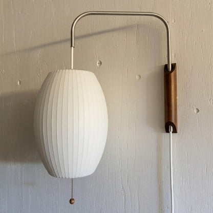 Nelson style bubble wall sconce pair bedside primary bedroom mid century modern plug in walnut wood arm warm glow interior