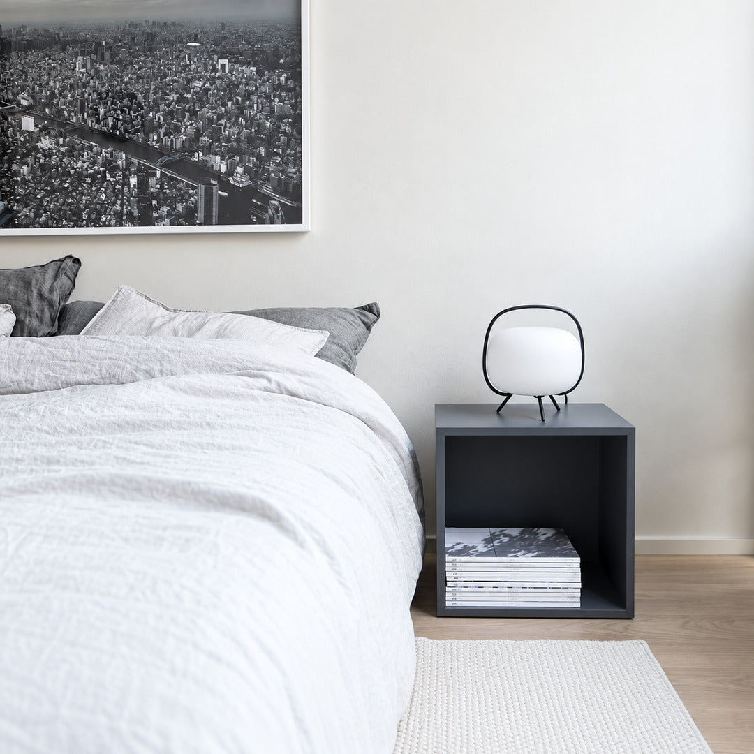 Pair of Nomade glass table lamps on matching nightstands beside a bed