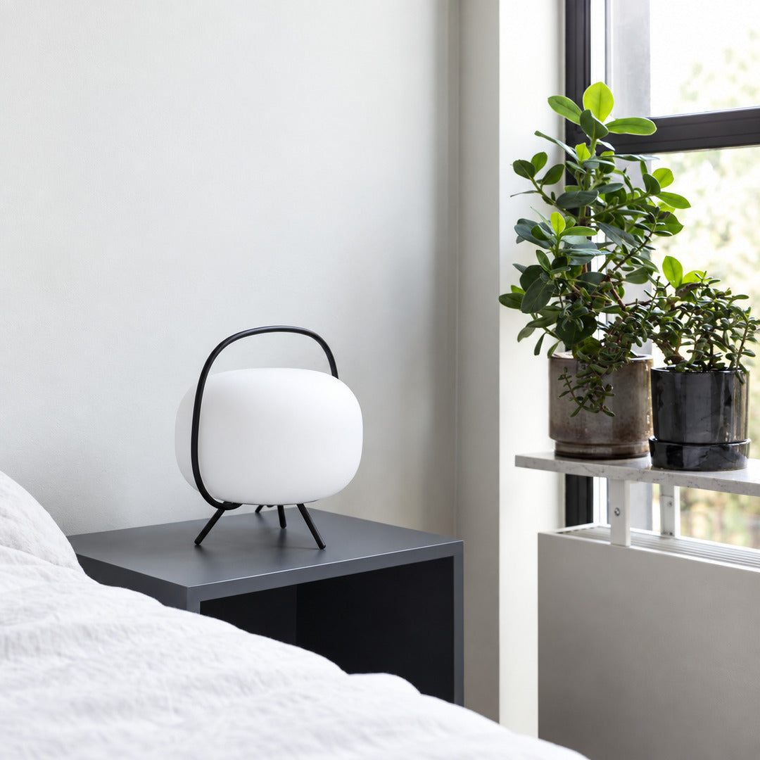 Pair of Nomade glass table lamps on matching nightstands beside a bed