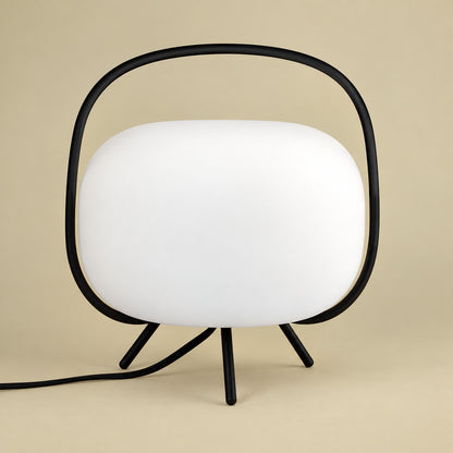 Black and white Nomade frosted glass lantern table lamp on a side table