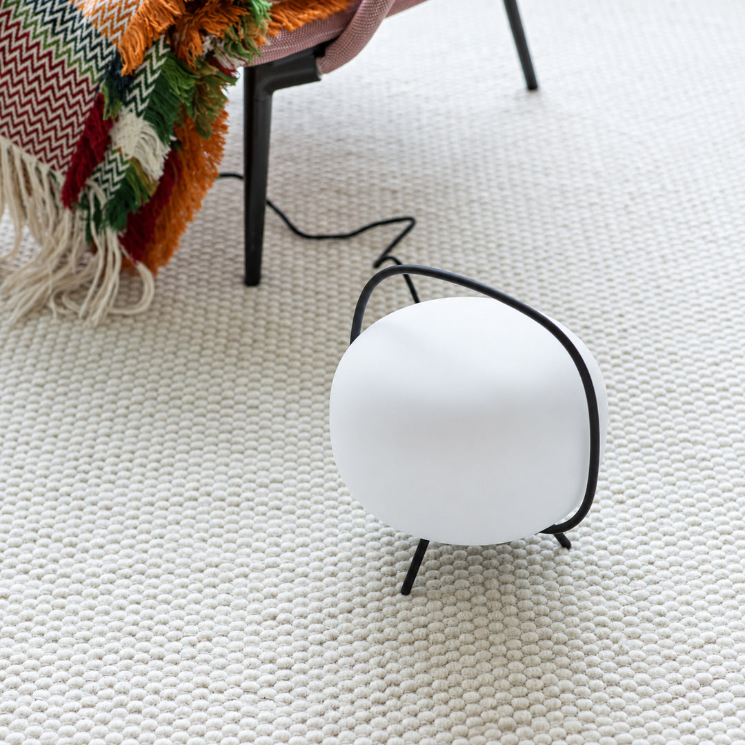 Nomade glass table lamp adding a warm accent on a dining room sideboard