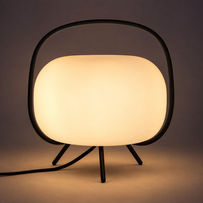 Soft warm glow diffusing evenly through the frosted glass shade of the Nomade table lamp