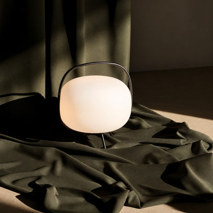 Nomade glass table lamp blending into a warm modern transitional living room