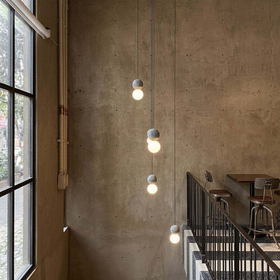 Norra concrete mini pendant cluster staircase stairwell vertical hanging different heights statement modern interior