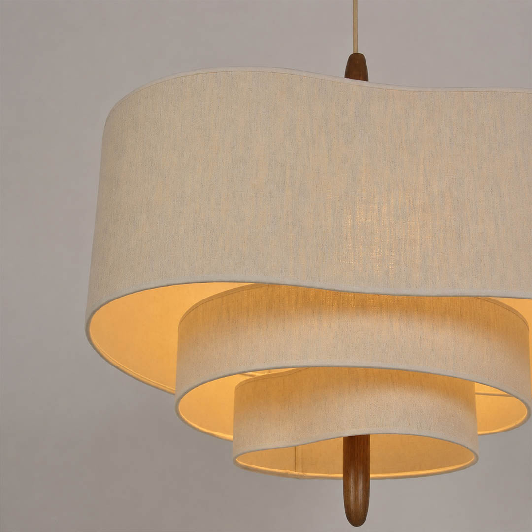 Nuvola pendant light illuminated warm ambient soft off-white glow multi-layered fabric shade evening cozy sophisticated mid-century boho detail close up mood