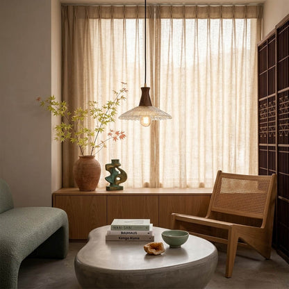 Olive pendant light above small dining table cozy warm glass wood transitional interior