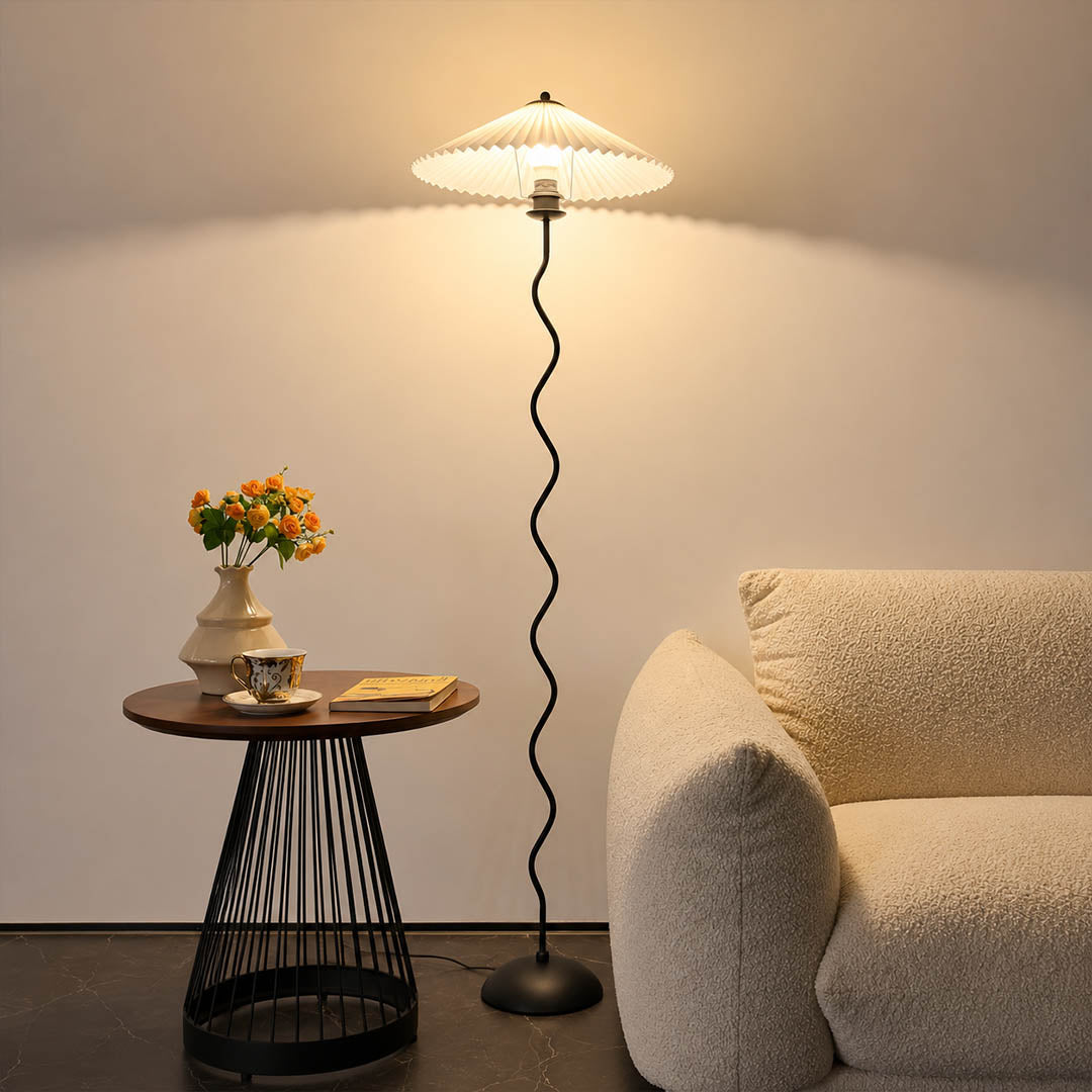 Onda floor lamp beige modern reading corner armchair sculptural squiggle wavy black metal base fabric drum shade postmodern Memphis inspired warm cozy ambient lifestyle interior
