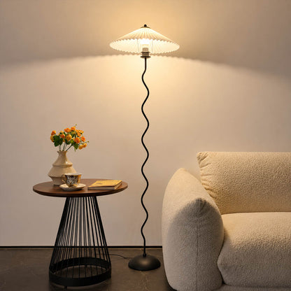 Onda floor lamp beige modern reading corner armchair sculptural squiggle wavy black metal base fabric drum shade postmodern Memphis inspired warm cozy ambient lifestyle interior