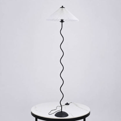 Onda floor lamp beige modern reading corner armchair sculptural squiggle wavy black metal base fabric drum shade postmodern Memphis inspired warm cozy ambient lifestyle interior