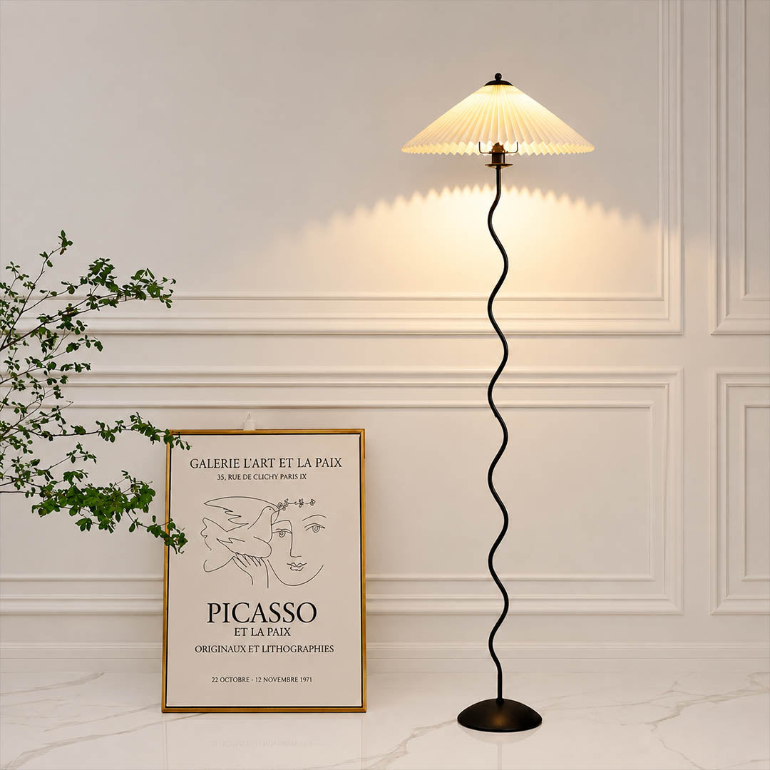 Onda floor lamp beige modern reading corner armchair sculptural squiggle wavy black metal base fabric drum shade postmodern Memphis inspired warm cozy ambient lifestyle interior