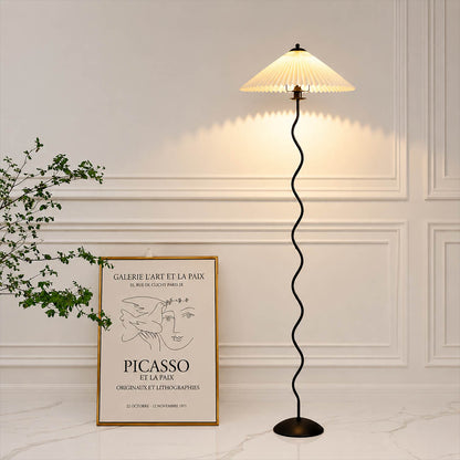 Onda floor lamp beige modern reading corner armchair sculptural squiggle wavy black metal base fabric drum shade postmodern Memphis inspired warm cozy ambient lifestyle interior