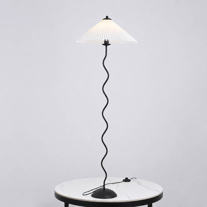 Onda floor lamp beige modern reading corner armchair sculptural squiggle wavy black metal base fabric drum shade postmodern Memphis inspired warm cozy ambient lifestyle interior