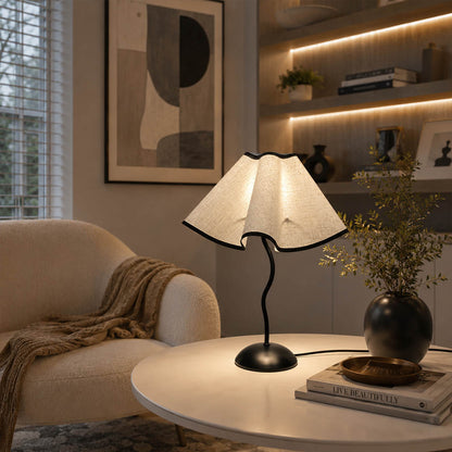Onda table lamp modern reading corner side table armchair cozy intimate vintage inspired warm ambient sculptural squiggly base pleated shade elegant lifestyle interior