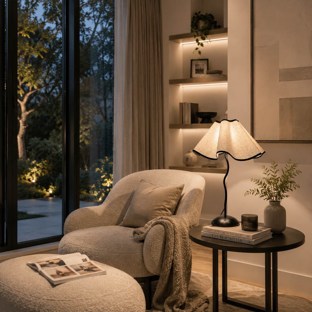Onda table lamp modern reading corner side table armchair cozy intimate vintage inspired warm ambient sculptural squiggly base pleated shade elegant lifestyle interior
