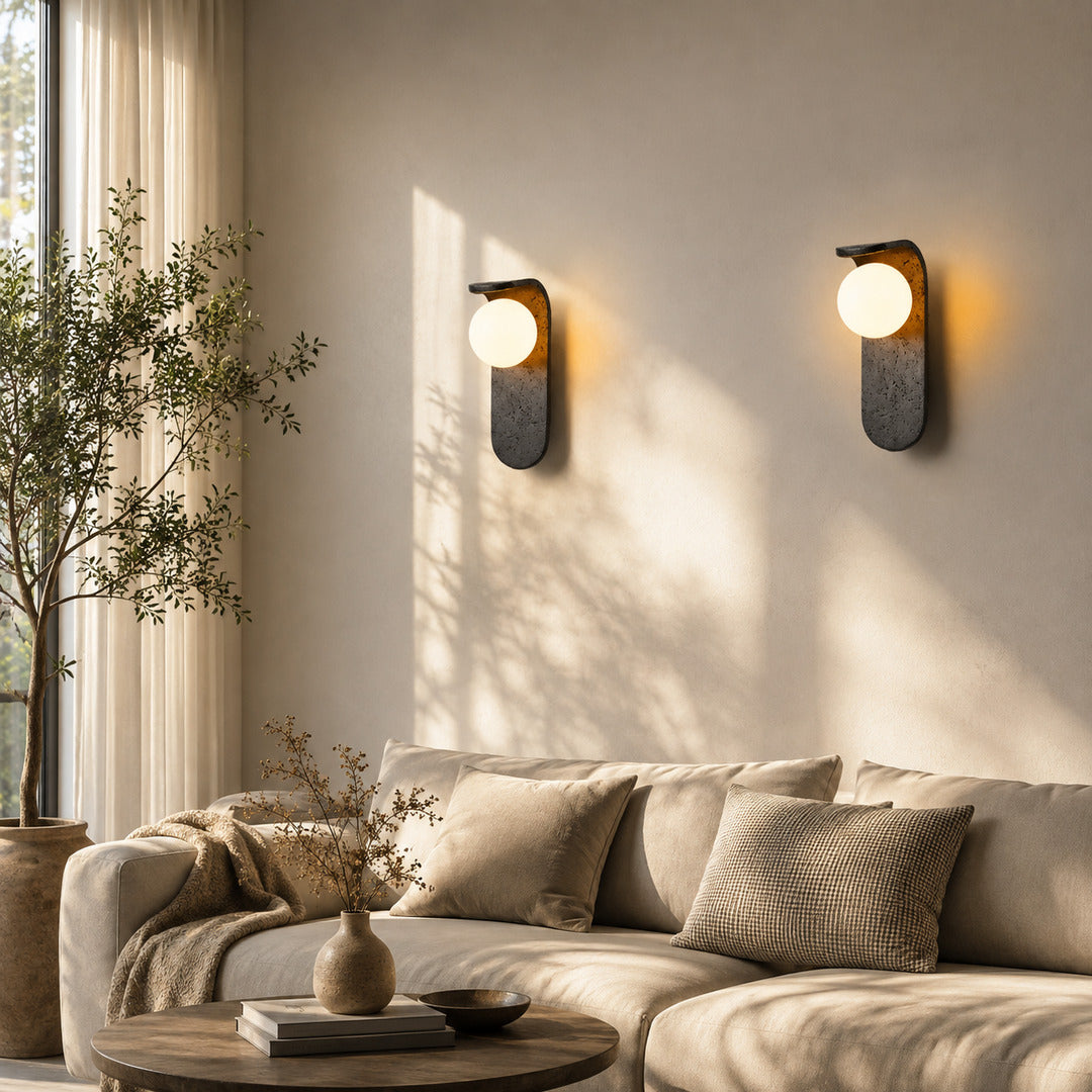 Notte travertine wall sconce living room wall warm glow black travertine stone orb sculptural American home lifestyle interior styled