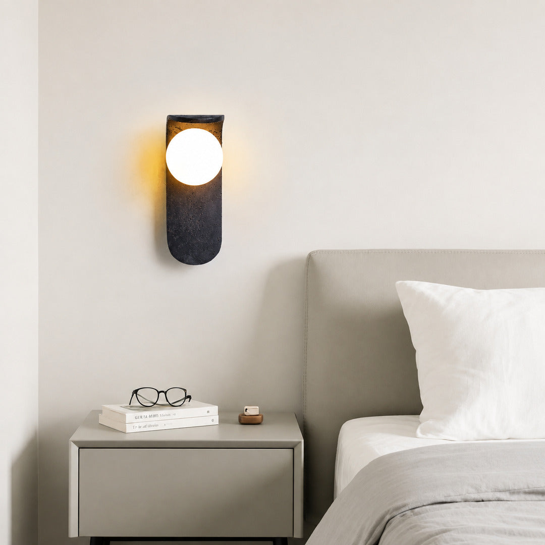 Notte travertine wall sconce bedroom bedside warm glow black travertine stone orb minimalist American home lifestyle interior styled