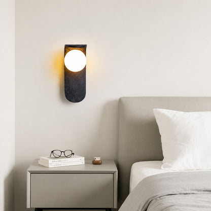 Notte travertine wall sconce bedroom bedside warm glow black travertine stone orb minimalist American home lifestyle interior styled