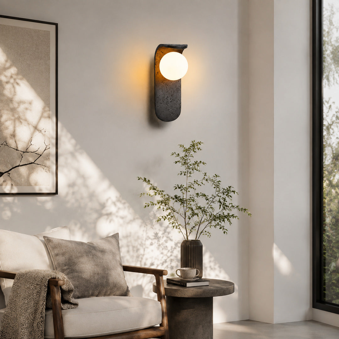 Notte travertine wall sconce living room wall warm glow black travertine stone orb sculptural American home lifestyle interior styled