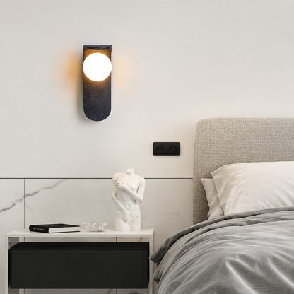 Notte travertine wall sconce bedroom bedside warm glow black travertine stone orb minimalist American home lifestyle interior styled