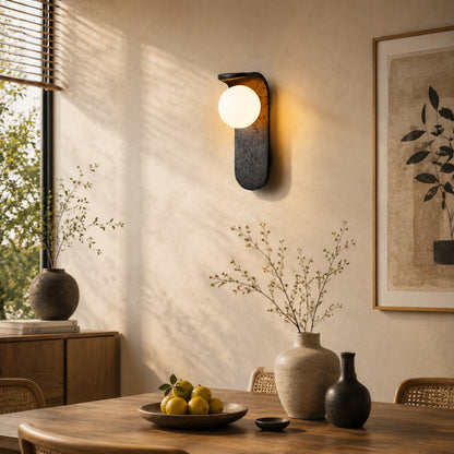 Notte travertine wall sconce living room wall warm glow black travertine stone orb sculptural American home lifestyle interior styled