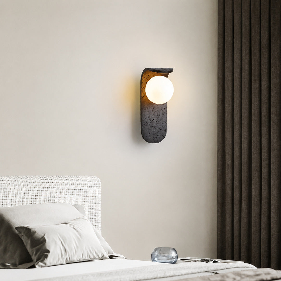 Notte travertine wall sconce bedroom bedside warm glow black travertine stone orb minimalist American home lifestyle interior styled