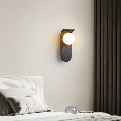 Notte travertine wall sconce bedroom bedside warm glow black travertine stone orb minimalist American home lifestyle interior styled