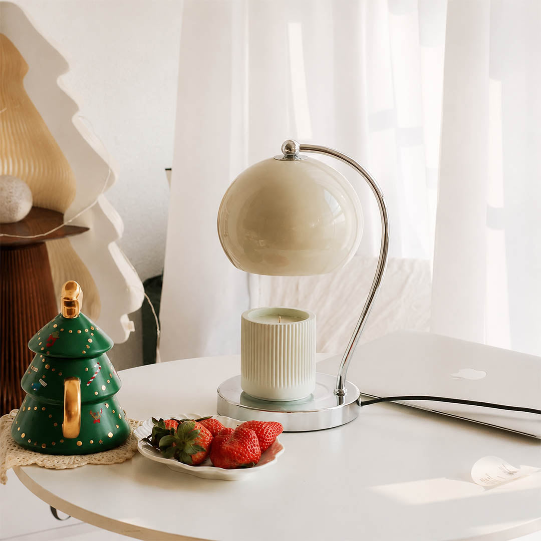 Orbet sphere candle warmer lamp living room side table scent warming warm glow chrome cute modern American home lifestyle interior styled
