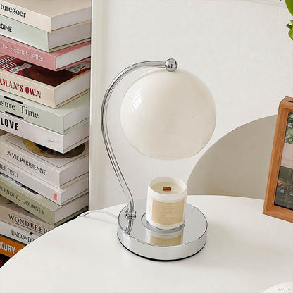 Orbet sphere candle warmer lamp living room side table scent warming warm glow chrome cute modern American home lifestyle interior styled