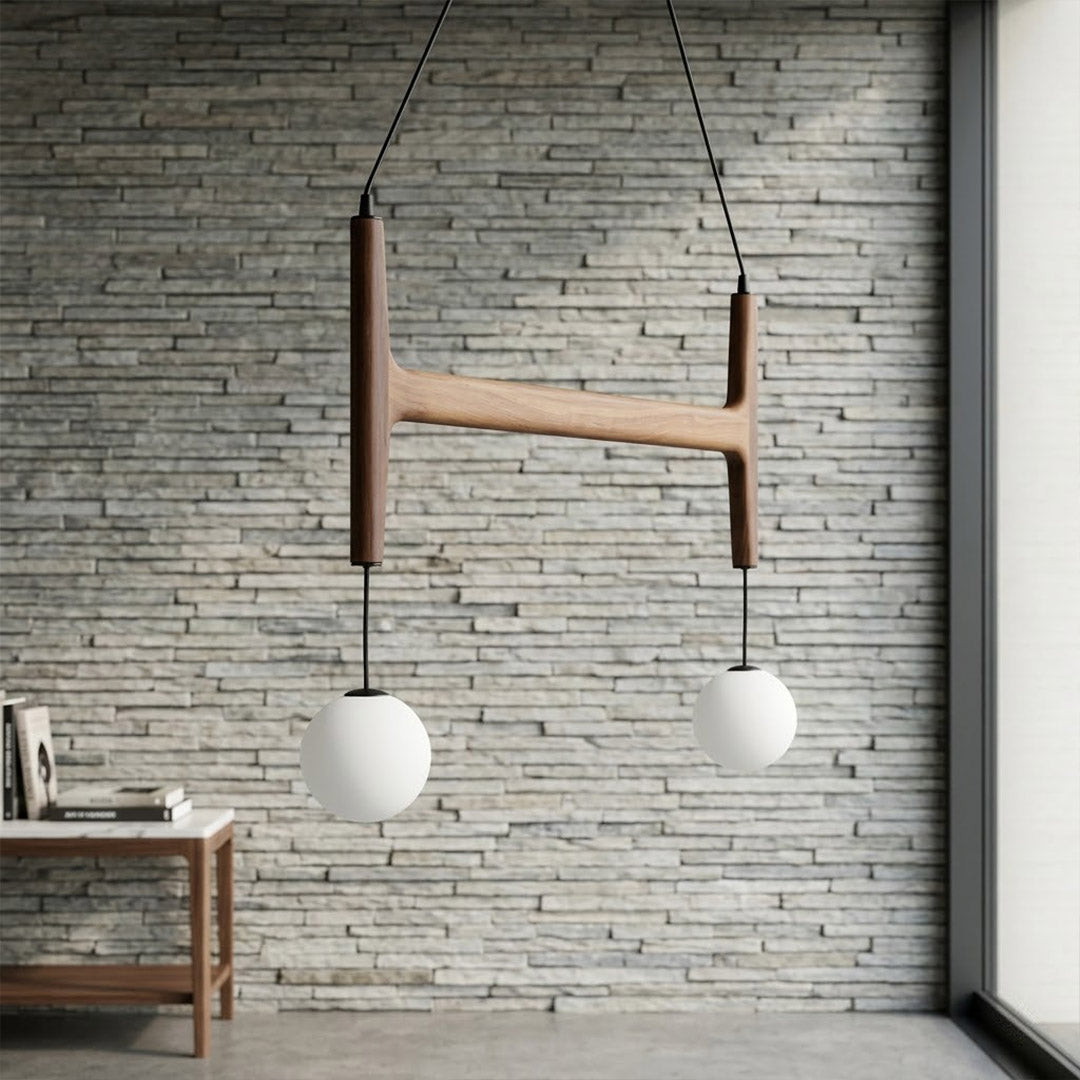 Orbit walnut orb chandelier above dining table warm frosted globe glow organic modern interior