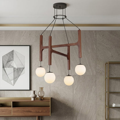 Orbit walnut orb chandelier above dining table warm frosted globe glow organic modern interior