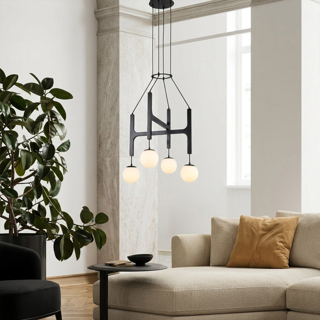 Orbit walnut orb chandelier above dining table warm frosted globe glow organic modern interior