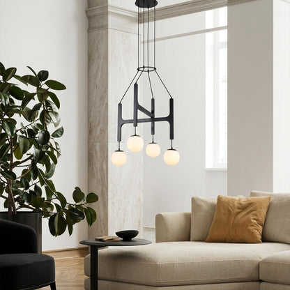 Orbit walnut orb chandelier above dining table warm frosted globe glow organic modern interior