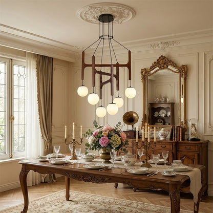 Orbit walnut orb chandelier above dining table warm frosted globe glow organic modern interior