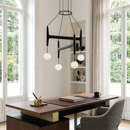 Orbit walnut orb chandelier above dining table warm frosted globe glow organic modern interior