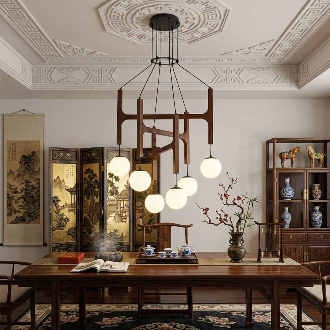 Orbit walnut orb chandelier above dining table warm frosted globe glow organic modern interior