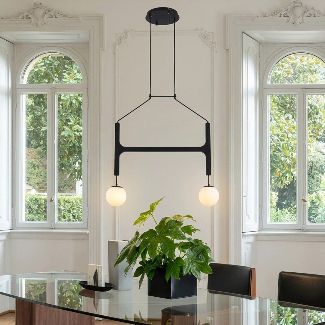 Orbit walnut orb chandelier above dining table warm frosted globe glow organic modern interior