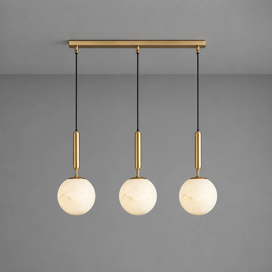 Orbita alabaster globe pendant light three balls linear natural stone spheres brass rods white background front view