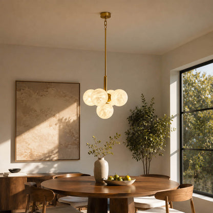 Orbita alabaster globe pendant light dining room above table cluster natural stone brass warm glow American home lifestyle interior styled