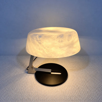 Close-up of natural veining glowing through the alabaster shade of the Orbita table lamp