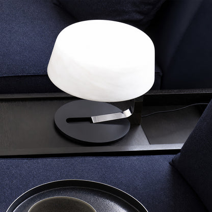 Orbita alabaster table lamp on a side table in a modern living room