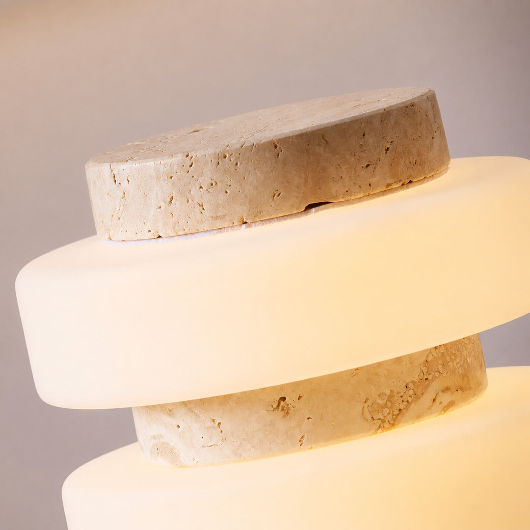 Orbita travertine table lamp three glowing glass rings warm diffused light saturn orbit detail close up
