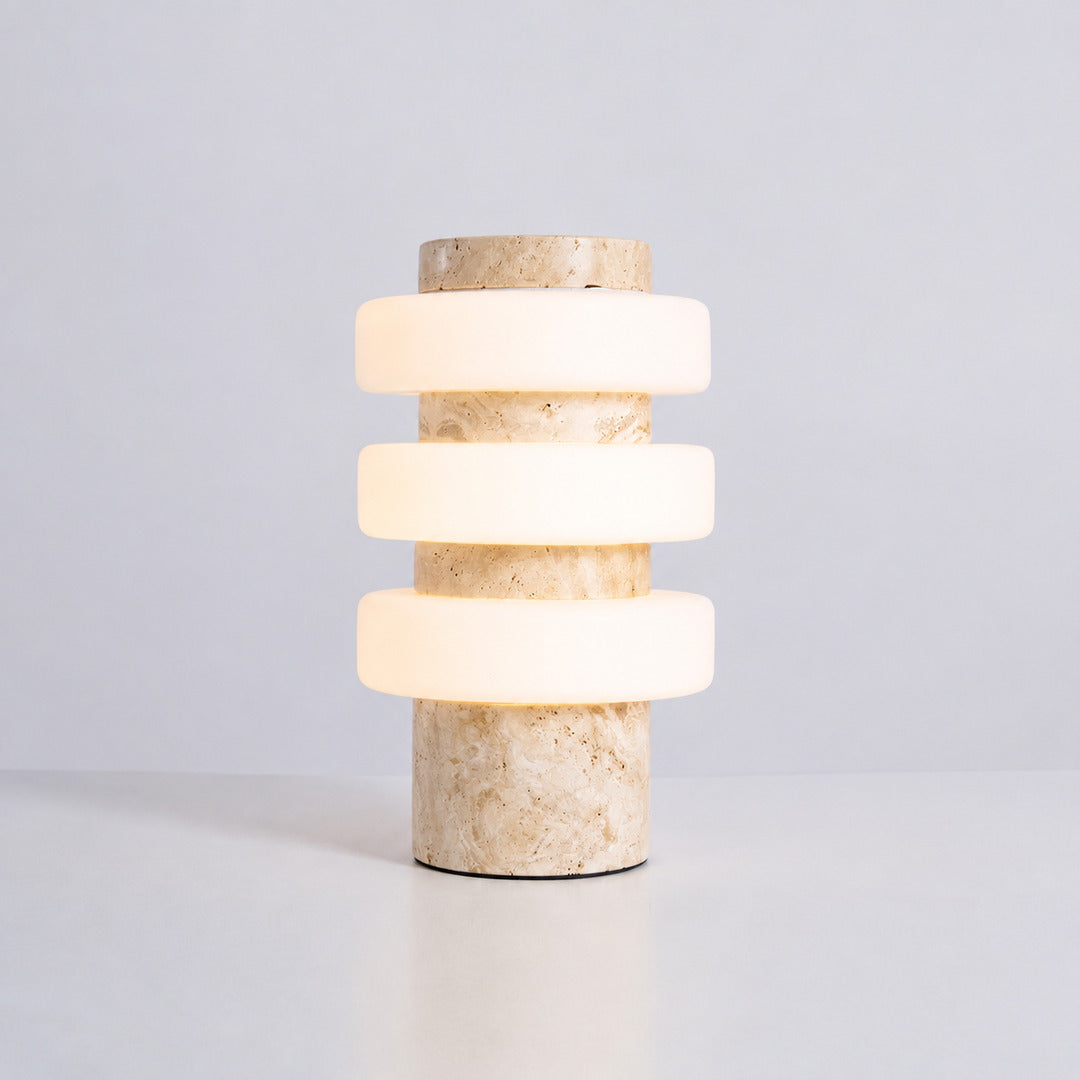 Orbita travertine table lamp yellow travertine stone base glowing glass rings sculptural saturn minimalist white background