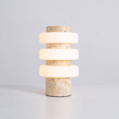 Orbita travertine table lamp yellow travertine stone base glowing glass rings sculptural saturn minimalist white background