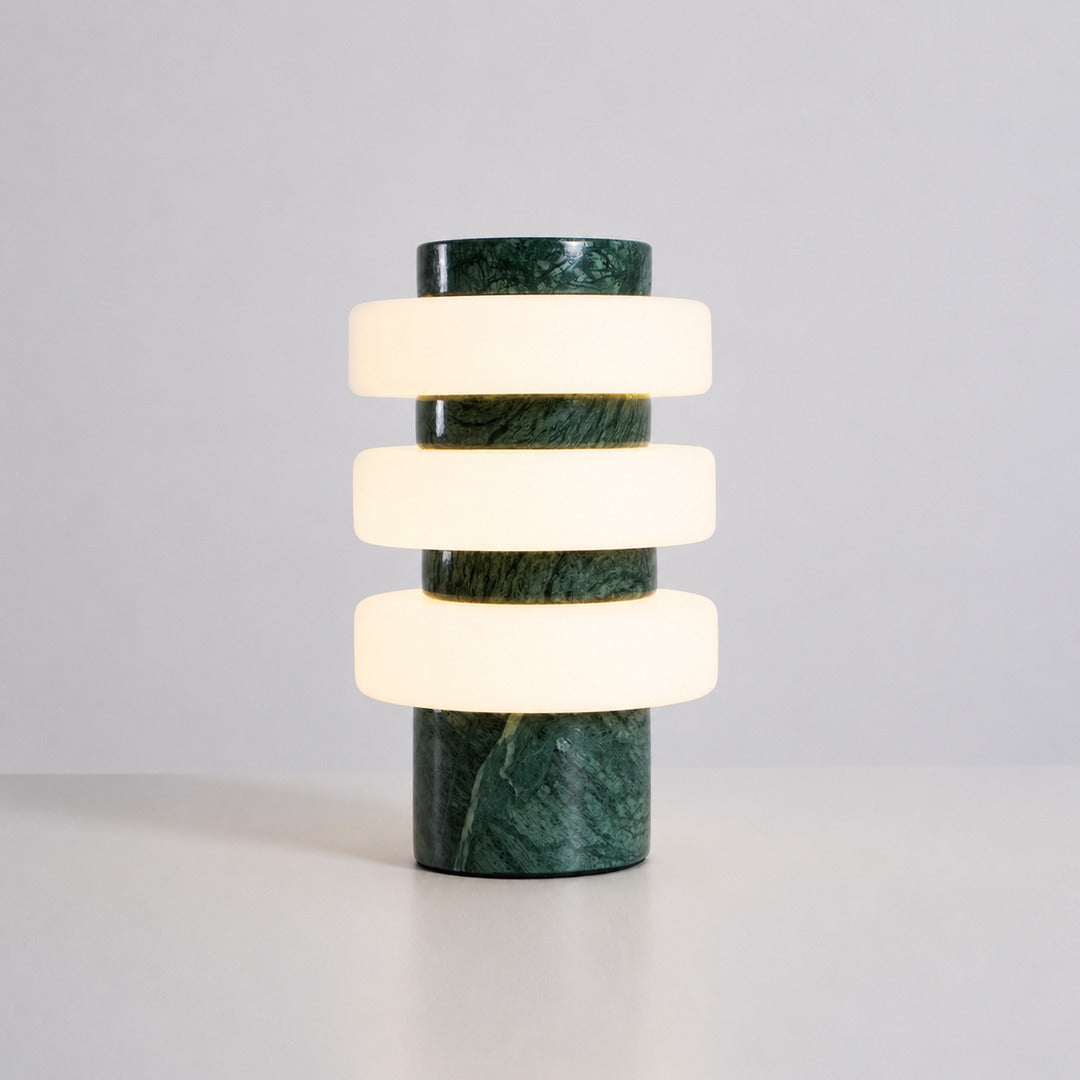 Orbita travertine table lamp green marble stone base glowing glass rings sculptural white background