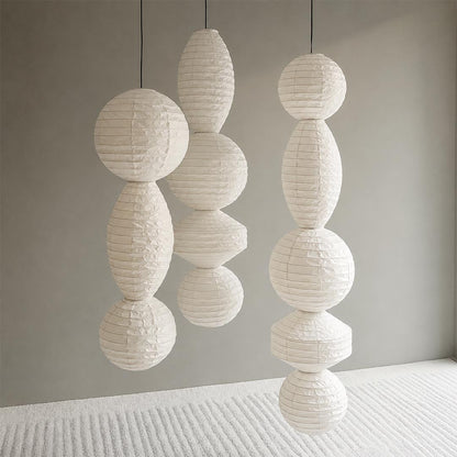 Three different styles of unlit Washi paper shades from the Ori Lantern Series hanging together against a grey wall by Stuber Lighting.