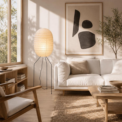 Sunlit Japandi living room featuring a tall capsule-shaped Washi Paper UF3-DL Floor Lamp near an abstract wall art by Stuber Lighting.
