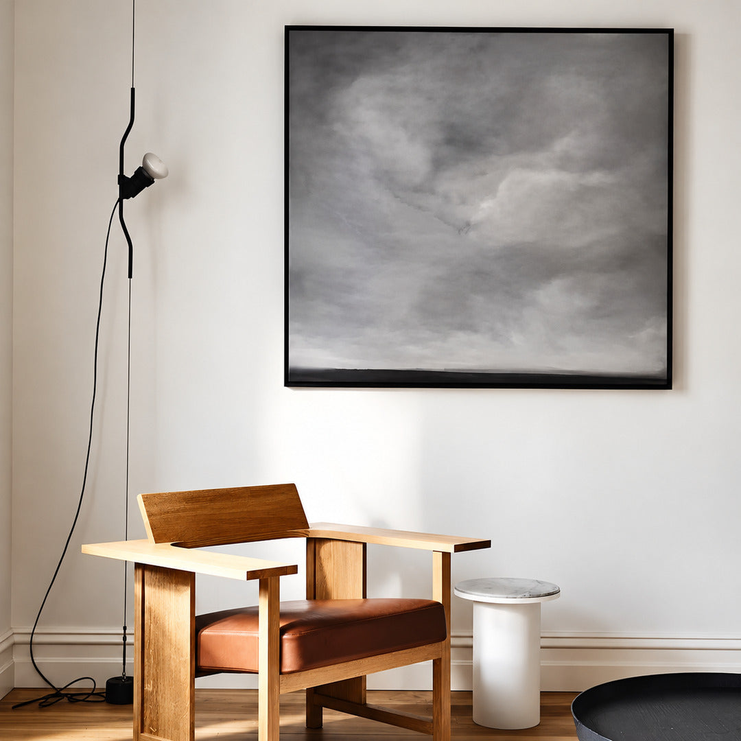 White Parentheses spotlight angled to light a large painting on a living room wall